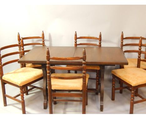 An oak drawleaf dining table, and six ladder back dining chairs, four single chairs and a pair of carver chairs. The upholste