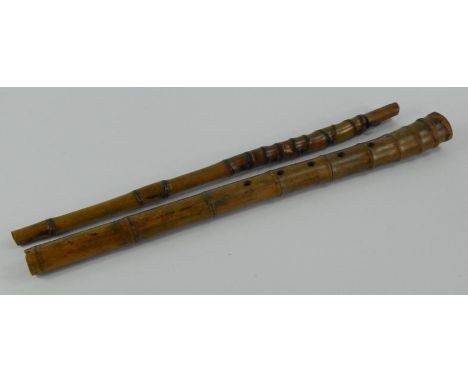 A bamboo walking stick flute, of primitive form, 95cm long