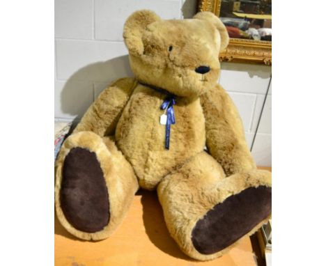 A very large jointed Hartley Bear's Emporium teddy bear in light tan plush, dark tan suede paw pads, glass eyes and stitched 