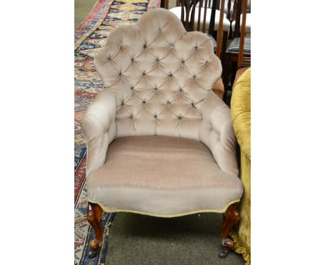 A Victorian button back armchair