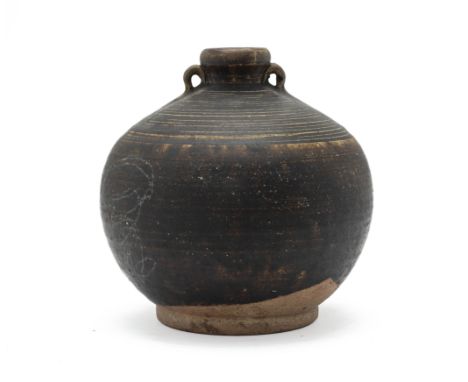 A SAWANKHALOK TWIN HANDLED JAR
Probably 15th C., with twin loop handles, the shoulder with incised banded decoration, the thi