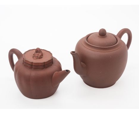 TWO YIXING POTTERY TEAPOTS
A melon fluted example, with a mythical beast finial to the cover; and a large plain spherical exa