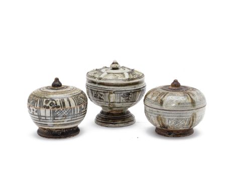 THREE SAWANKHALOK BOXES AND COVERS
Circa 16th C., Two similar examples decorated with alternating panels; and a larger exampl