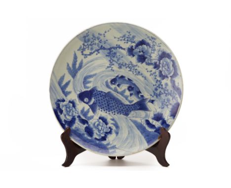 A VERY LARGE JAPANESE BLUE AND WHITE CHARGER
Late 19th C., decorated with koi, prunus and flowering branches (repaired)
62cm 