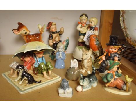 A Walt Disney Japan model of Bambi with a butterfly on his tail; a Royal Copenhagen mouse; another; a Goebel figure group imp