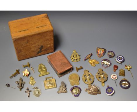 A small oak box containing military badges and Trench  Art.