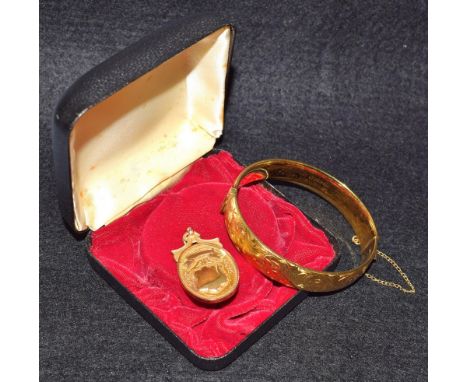 A 9ct rose gold fob, 7.3g; a rolled gold hinged bangle (2) 