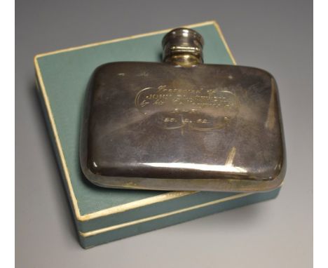 A hallmarked silver hip flask, boxed.