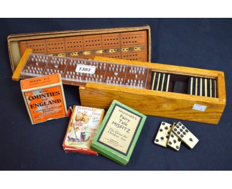 A set of bone and ebony double nine dominoes; Jaques playing cards; a cribbage board; card games (5)