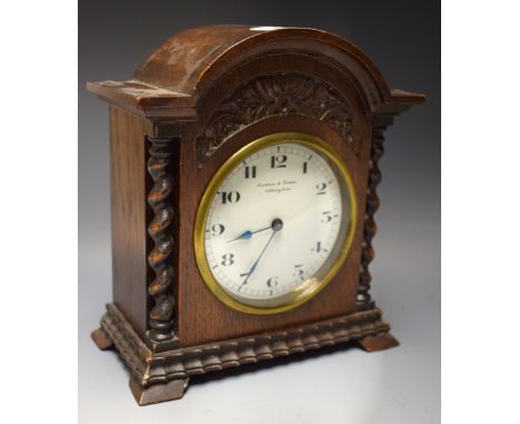 An oak cased mantel clock, enamel dial, Butcher and Swan, Nottingham
