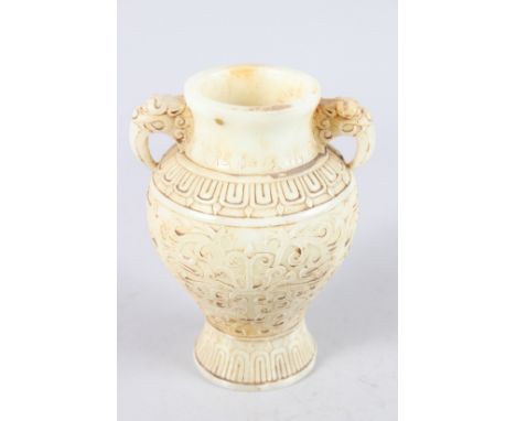 A CHINESE CARVED TWO HANDLED WHITE JADE VASE. 8ins high.