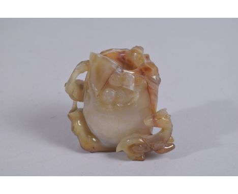 A FINE CHINESE NATURALISTIC CARVED JADE BRUSH WASHER VASE, with relief deer and crane and foliate designs, 8.5cm high.