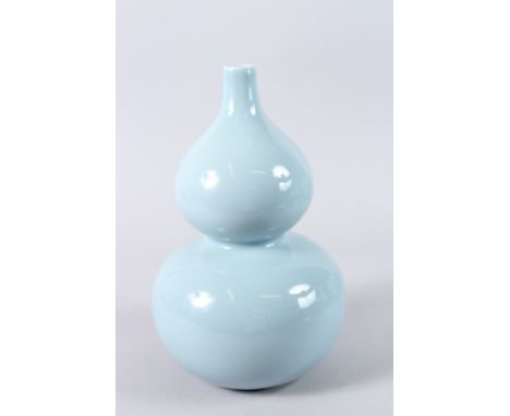 A CHINESE PORCELAIN GOURD SHAPE VASE, with powder blue glaze, square seal mark to the base. 32cms high.