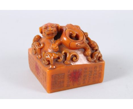 A CHINESE CARVED HARDSTONE SQUARE SHAPED SEAL. 11cms wide.