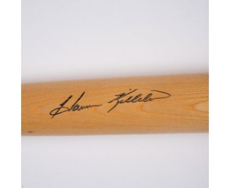 Natural wood-colored bat signed by Harmon Killebrew. This item comes in a plastic protective case that measures 36.5"L x 9.5"