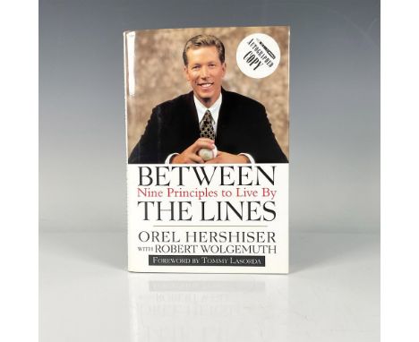 Between the Lines: Nine Principles to Live By, a hardcover book with original dustcover and 172 pages. Autographed by Orel He