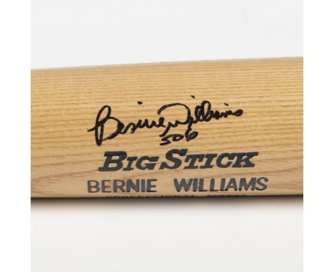 A natural wood bat with elegant black and blue accents signed by Bernie Williams. Rawlings marked. Certificate of Authenticit