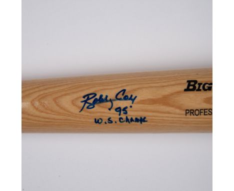 This light wood-colored bat features a blue ring accent and black text logo, with Bobby Coxs autograph in blue ink. Rawlings 