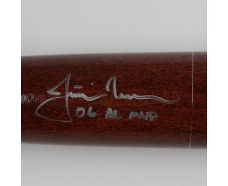 This is a hard maple brown and light natural wood-colored bat signed by 2006 AL MVP Justin Morneau. Signature certified authe