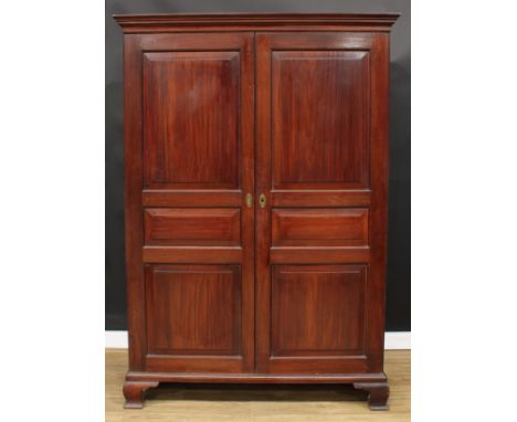 A 19th century mahogany wardrobe, moulded cornice above a pair of raised and fielded panel doors, ogee bracket feet, 201cm hi