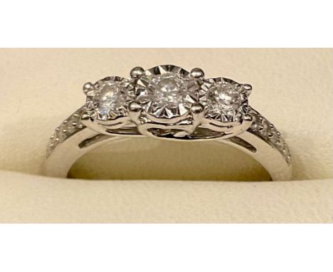 A diamond three stone ring, linear set with three diamonds, 9ct white gold shank, size N, 2.8g gross 