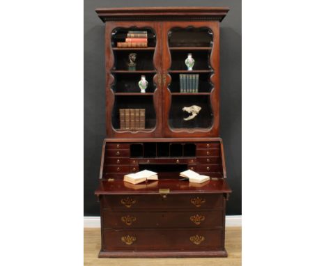 A 19th century mahogany bureau bookcase, dentil cornice above a pair of glazed doors enclosing three adjustable shelves and t