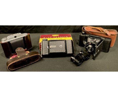 A Kershaw camera, boxed; two other similar cameras; a pair of Kershaw wide-angle opera glasses 