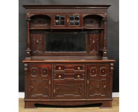 A Jacobean Revival oak sideboard, outswept cornice above a pair of doors and a bevelled rectangular mirror, the projecting ba