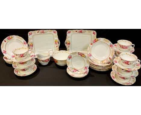 A Radfords part tea service comprising cake plates, side plates, cream jug, sugar bowl, cups and saucers, early 20th century 