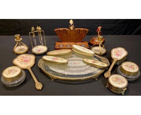 An Art Deco carved wooden pipe stand, mounted with nut bird; another, ashtray; a petit point dressing table set comprising ma