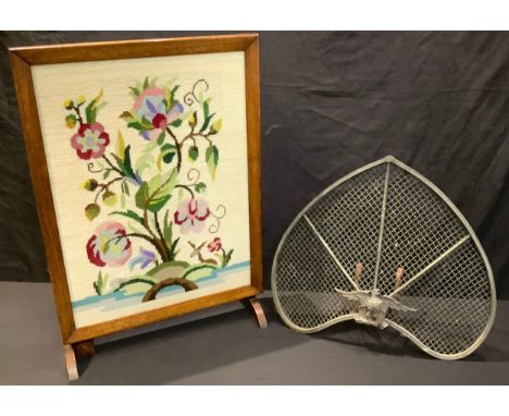 A 19th century French inverted heart shaped fire screen, mounted with Napoleonic eagle; an oak metamorphic table/fire screen,