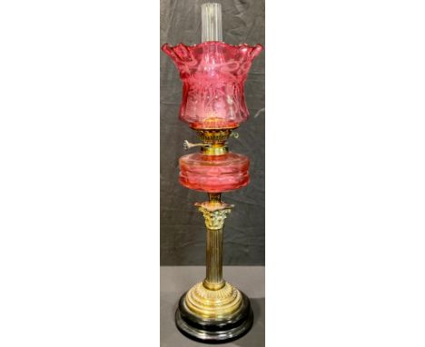 A late 19th century oil lamp, Wright &amp; Butler, Birmingham, etched cranberry glass shade, cranberry glass font, brass Cori