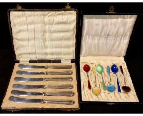 A set of six Norwegian silver and enamel spoons, cased; a set of six silver hafted tea knives, cased (2) 