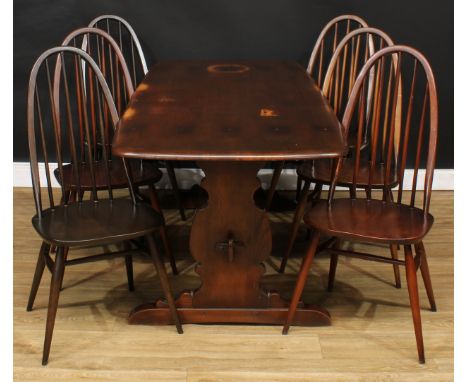 An Ercol dining table, 71.5cm high, 183cm long, 79.5cm wide; six Ercol Quaker dining chairs, 96cm high, 42.5cm wide, the seat