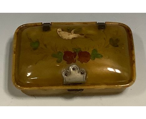 A 19th century painted horn rectangular snuff box, hinged cover decorated in polychrome with a dove and flowers, 10cm wide 