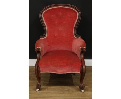 A Victorian mahogany spoonback armchair, boldly carved scroll arms, cabriole legs, ceramic casters, 105cm high, 69cm wide, th