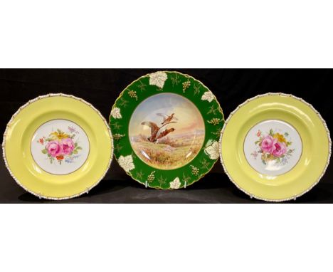 A pair of Royal Crown Derby cabinet plates, painted with flowers by Cuthbert Gresley, signed, yellow border, 22.5cm diameter,