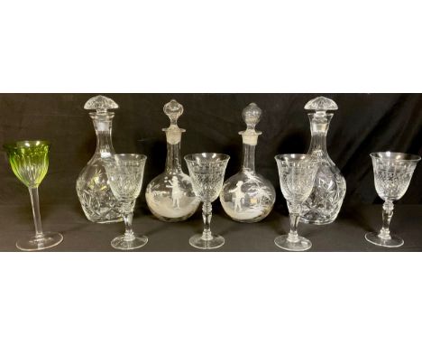 A pair of 19th century clear glass decanters, applied with white enamel in the style of Mary Gregory, decorated with children