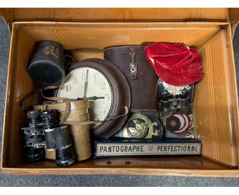 An early 20th century painted tin trunk with pre 1923 Railway luggage labels affixed with contents comprising of a windup Smi