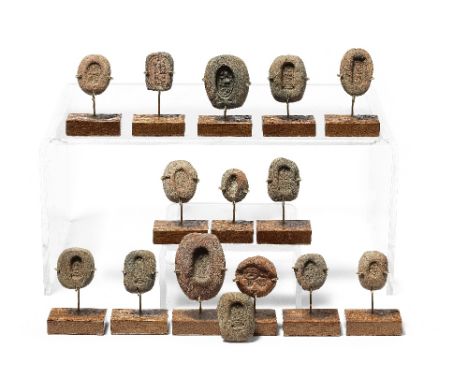  A group of 15 Egyptian pottery moulds for ring bezels and plaques New Kingdom, circa 1550-1069 B.C.Each approx. 3cm high  (1