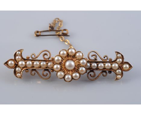 A LATE 19TH CENTURY PEARL SET BROOCH, the central flower head shaped mount set with graduating pearls, on a rectangular brooc