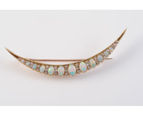 A LATE 19TH CENTURY OPAL AND DIAMOND SET CRESCENT BROOCH, the thirteen graduating oval cut opals alternately spaced with four