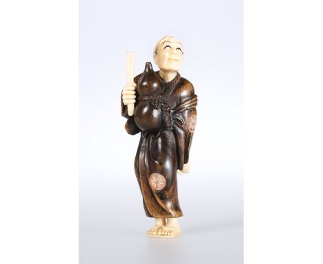 A JAPANESE IVORY AND WOOD FIGURAL NETSUKE, Meiji period, modelled with a gourd hung around the neck, signed. 7.5cm