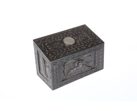 AN UNUSUAL IRISH CARVED BOG OAK STATIONERY BOX, LATE 19TH CENTURY, the sloping hinged cover opening to compartments and mount