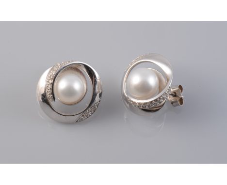 A PAIR OF CONTEMPORARY CULTURED PEARL AND DIAMOND SET EARRINGS, the swirled design mount set with subtle brilliant cut diamon