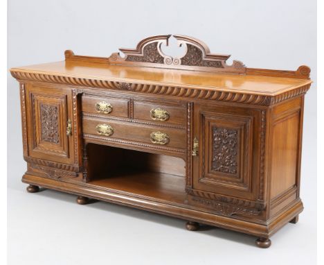 A LARGE VICTORIAN CARVED OAK SIDEBOARD, CIRCA 1870, with carved broken-arch pedimented back, the moulded rectangular top abov