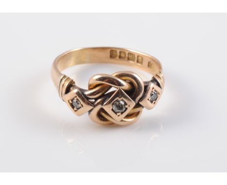 AN EDWARDIAN 18 CARAT GOLD KNOTWORK RING, London 1907, set with three diamonds. Ring size R 1/2. 6.5 grams