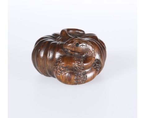 A JAPANESE CARVED WOODEN NETSUKE, carved as pumpkin and snake, signed. Diameter 4cm