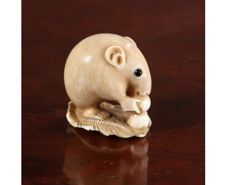 A JAPANESE IVORY NETSUKE OF A MOUSE, Meiji period, signed. 32mm