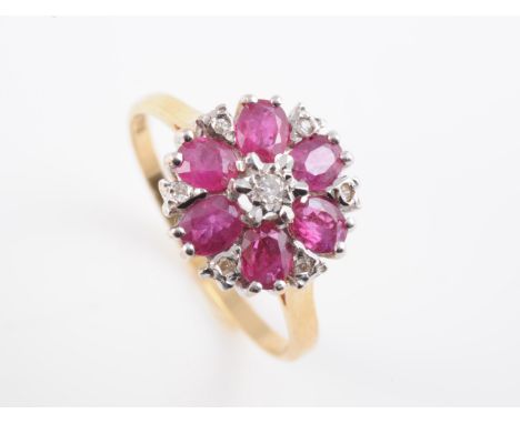 AN 18CT YELLOW GOLD, RUBY AND DIAMOND CLUSTER RING, the six oval cut ruby highlights set in an open work mount with seven bri